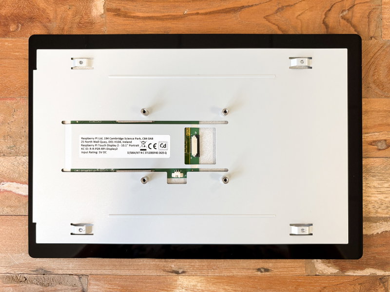 Two identical acrylic frame pieces slotted over the back of the display