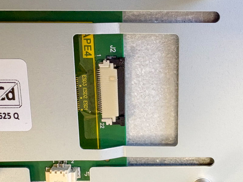 Close-up of display FFC connector tab being opened slightly