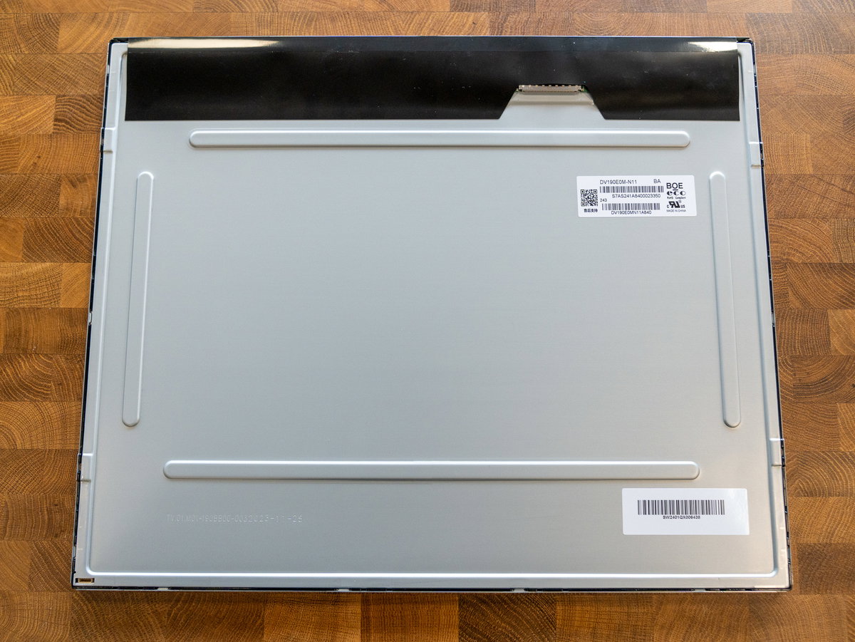 Display panel face-down with the ribbon connector at the top