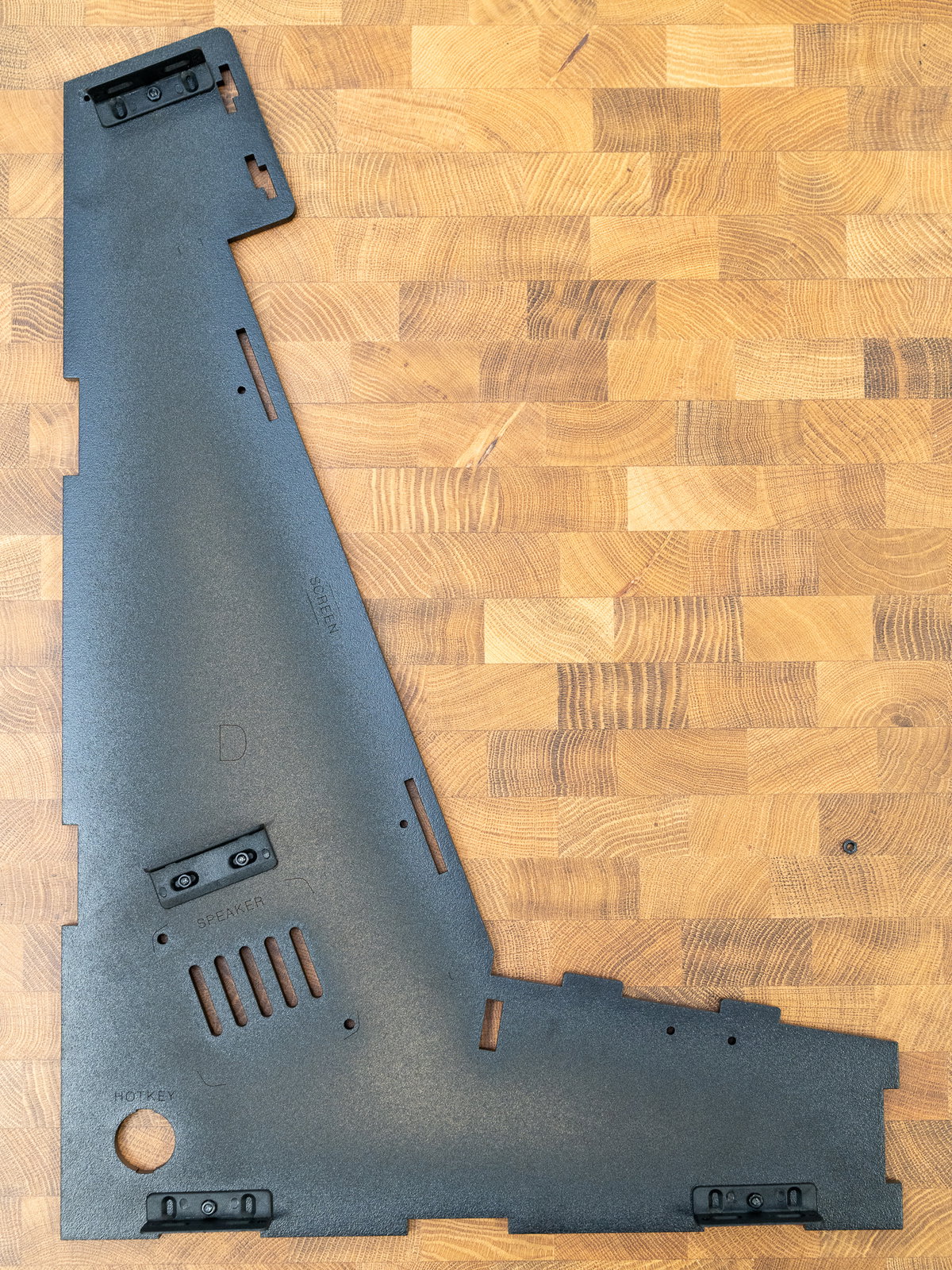 Four L-shaped brackets attached to panel D
