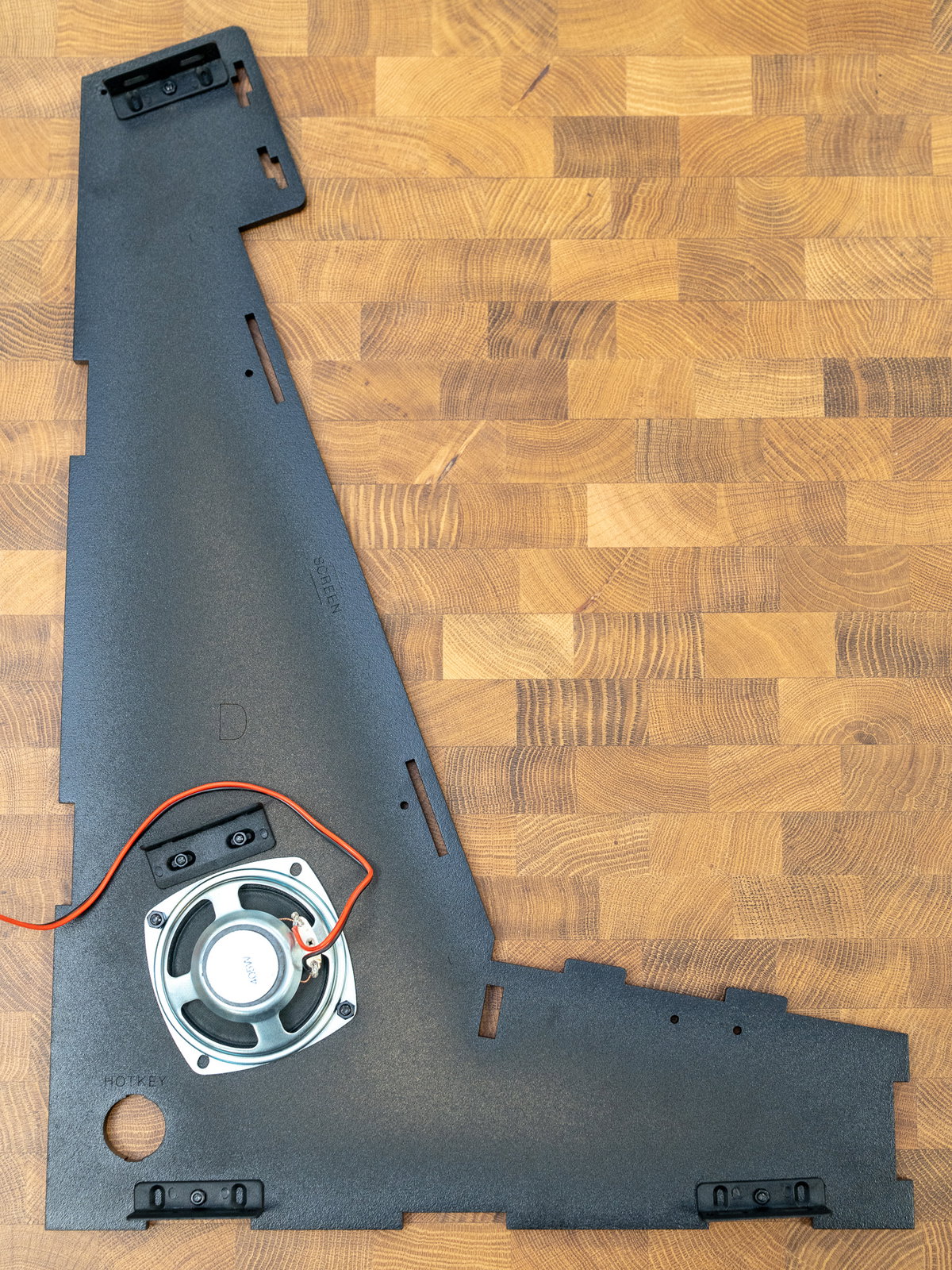 Speaker mounted over the grille on panel D