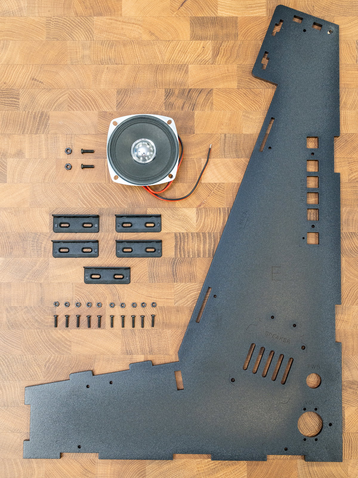 Panel E, brackets, speaker, and fixings ready for assembly