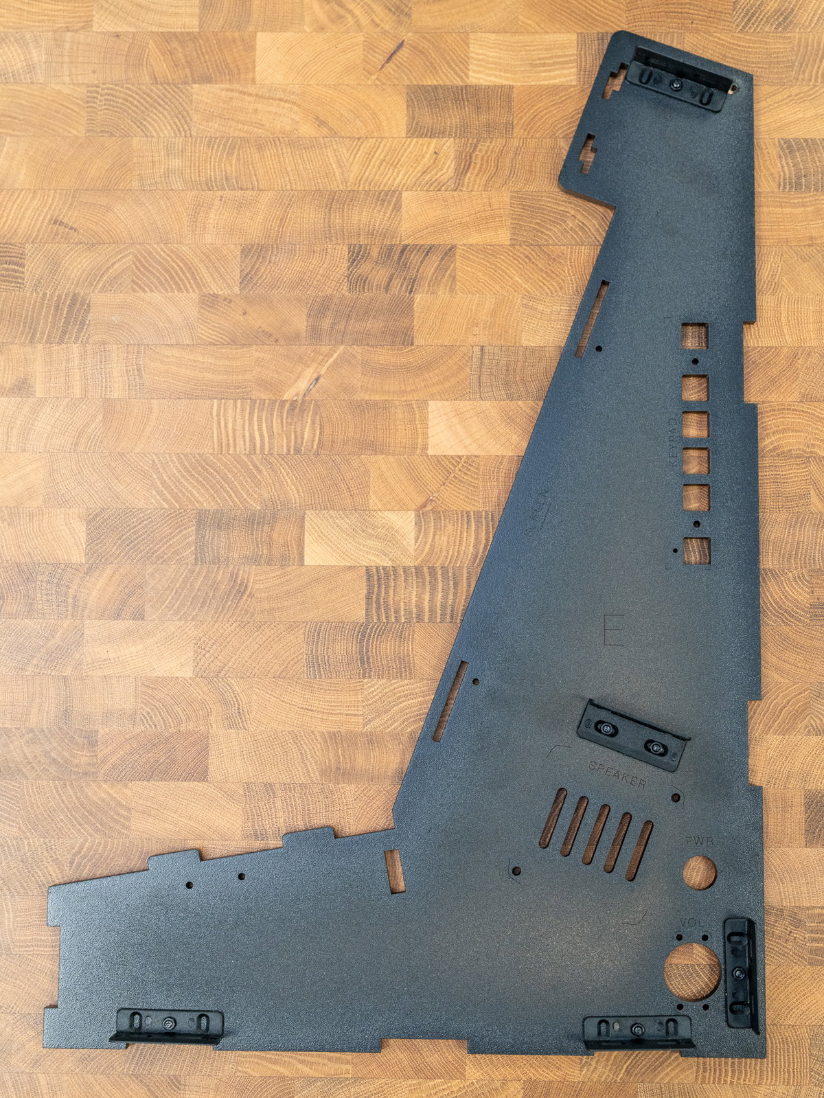 Five L-shaped brackets attached to the inside of panel E