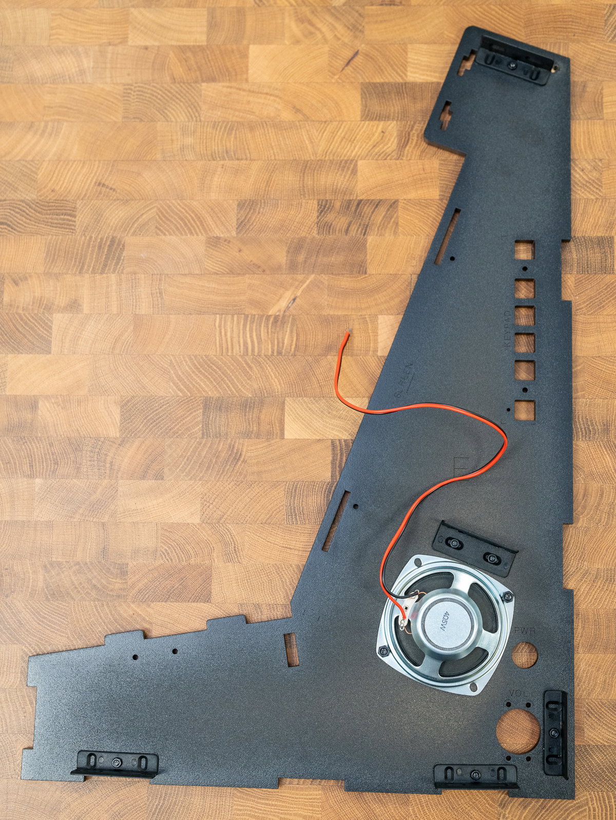Speaker mounted over the grille on panel E