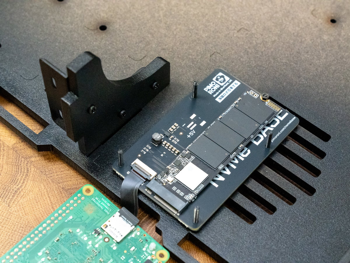 NVMe Base positioned on the M2.5 nuts with its ribbon cable facing forward