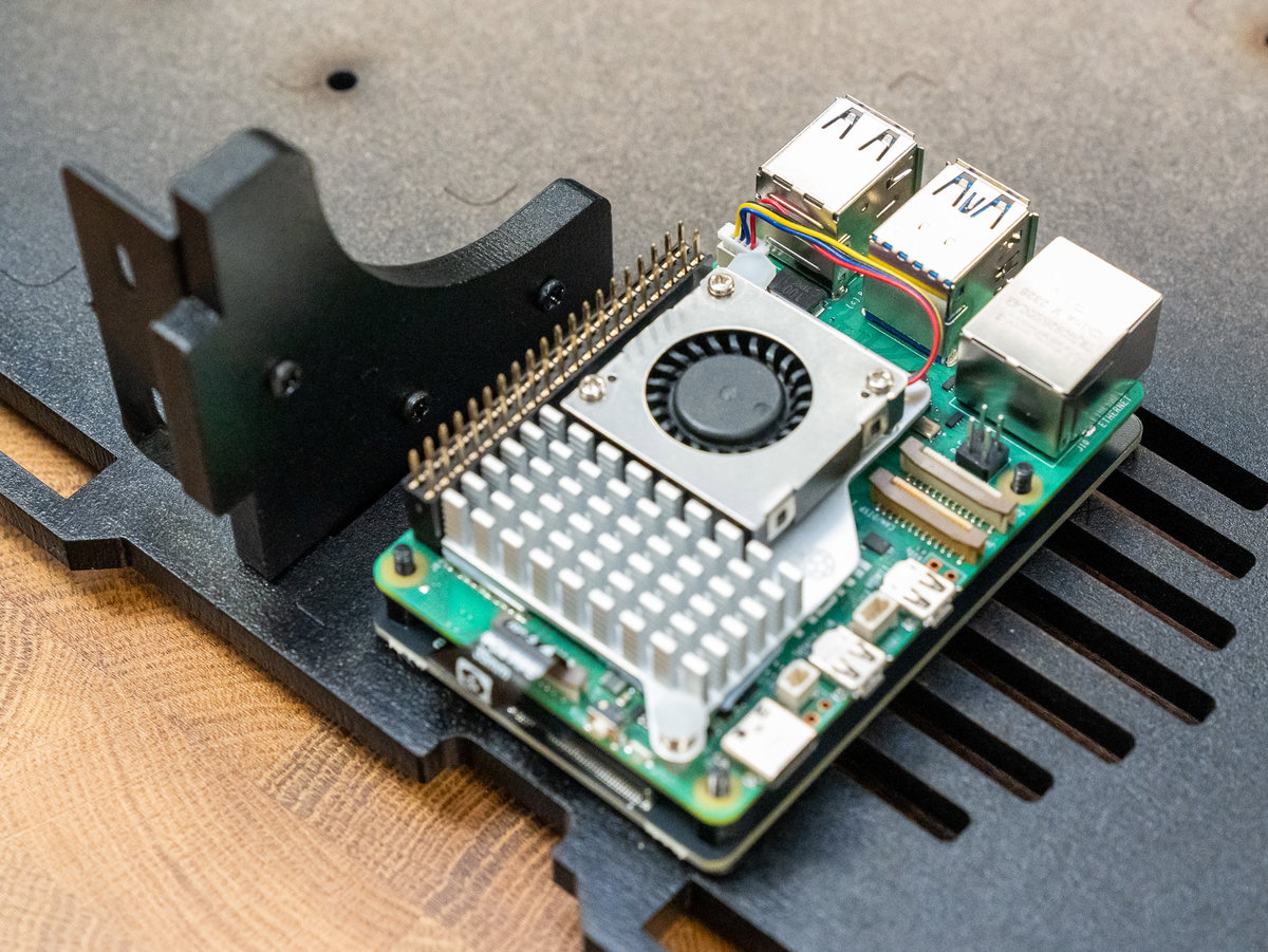 Raspberry Pi positioned above the NVMe Base with the PCIe cable connected