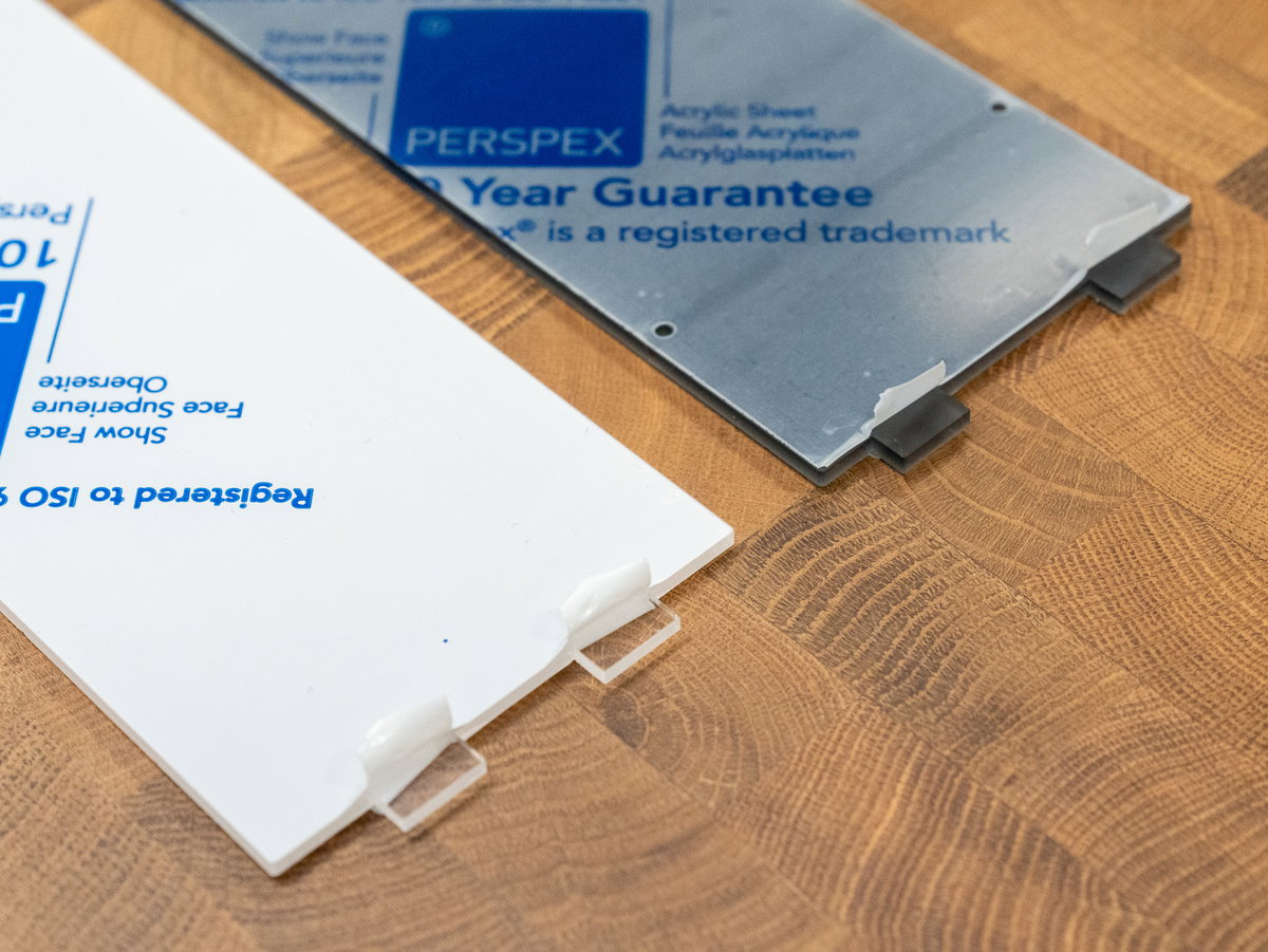 Protective backing removed from the tabs on one side of the acrylic marquee panels