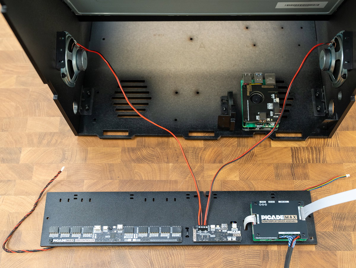 Speaker wires positioned at the screw terminals on the USB Audio board