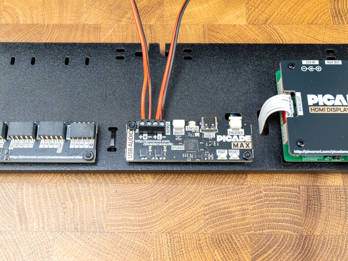 Red and black speaker wires connected to the USB Audio board