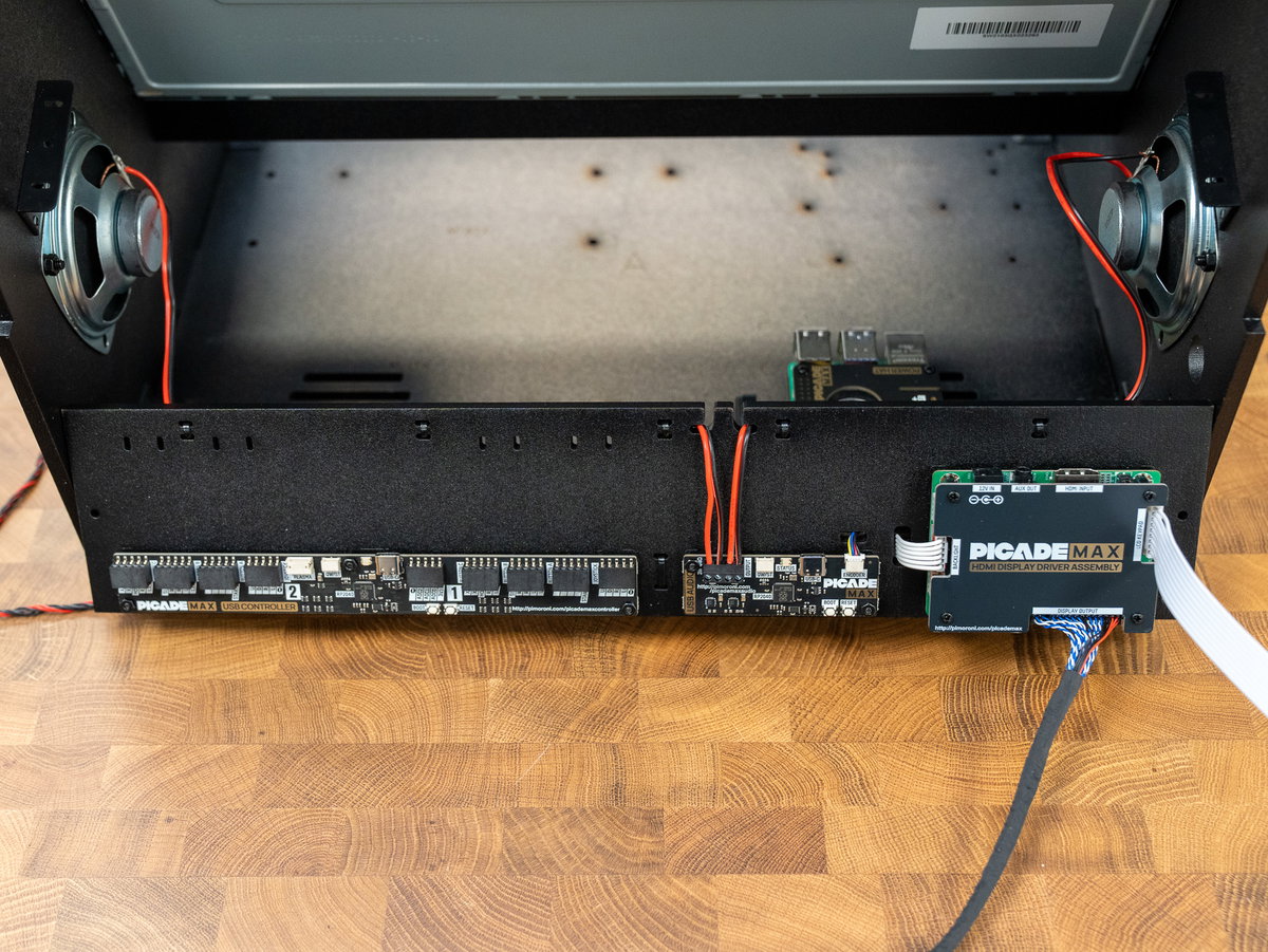 Speaker wires routed through the cutouts above the Audio board