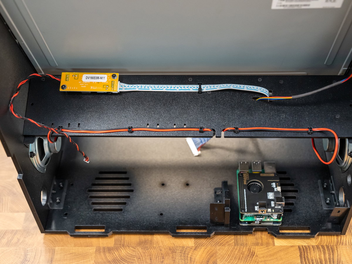 Speaker wires secured to the rear of panel K with cable ties