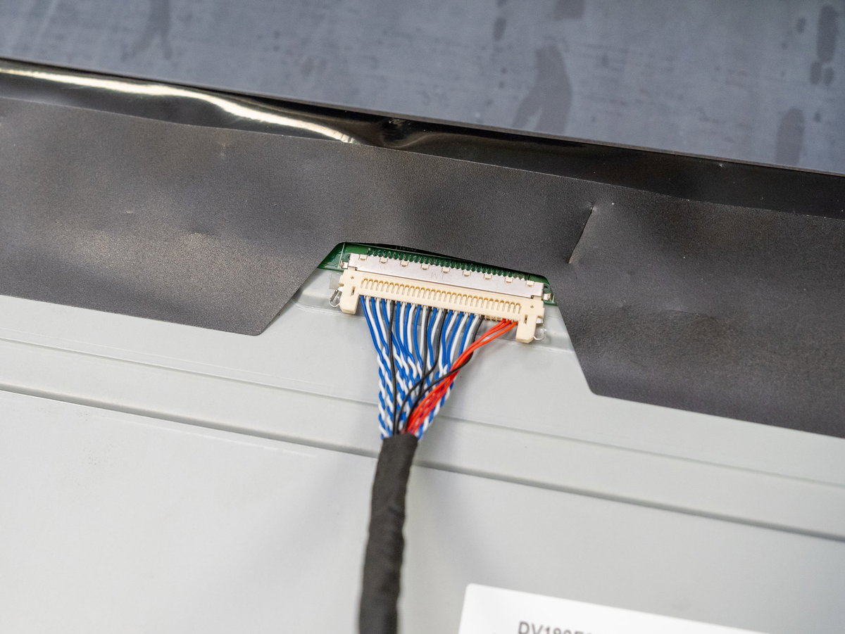Red, black, and blue cable connected to the upper display panel connector