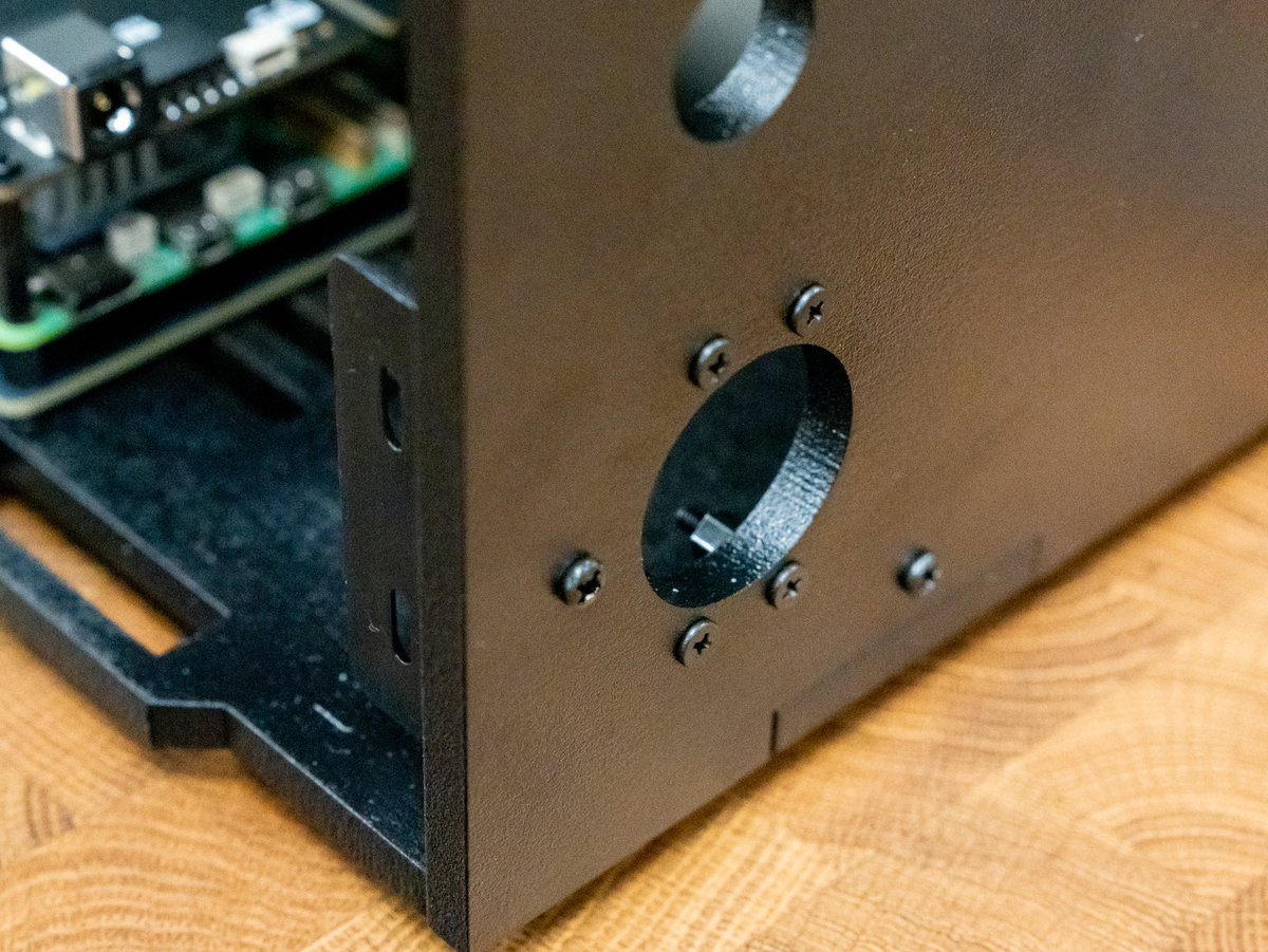 Flat-headed M2.5 screws inserted around the volume control opening
