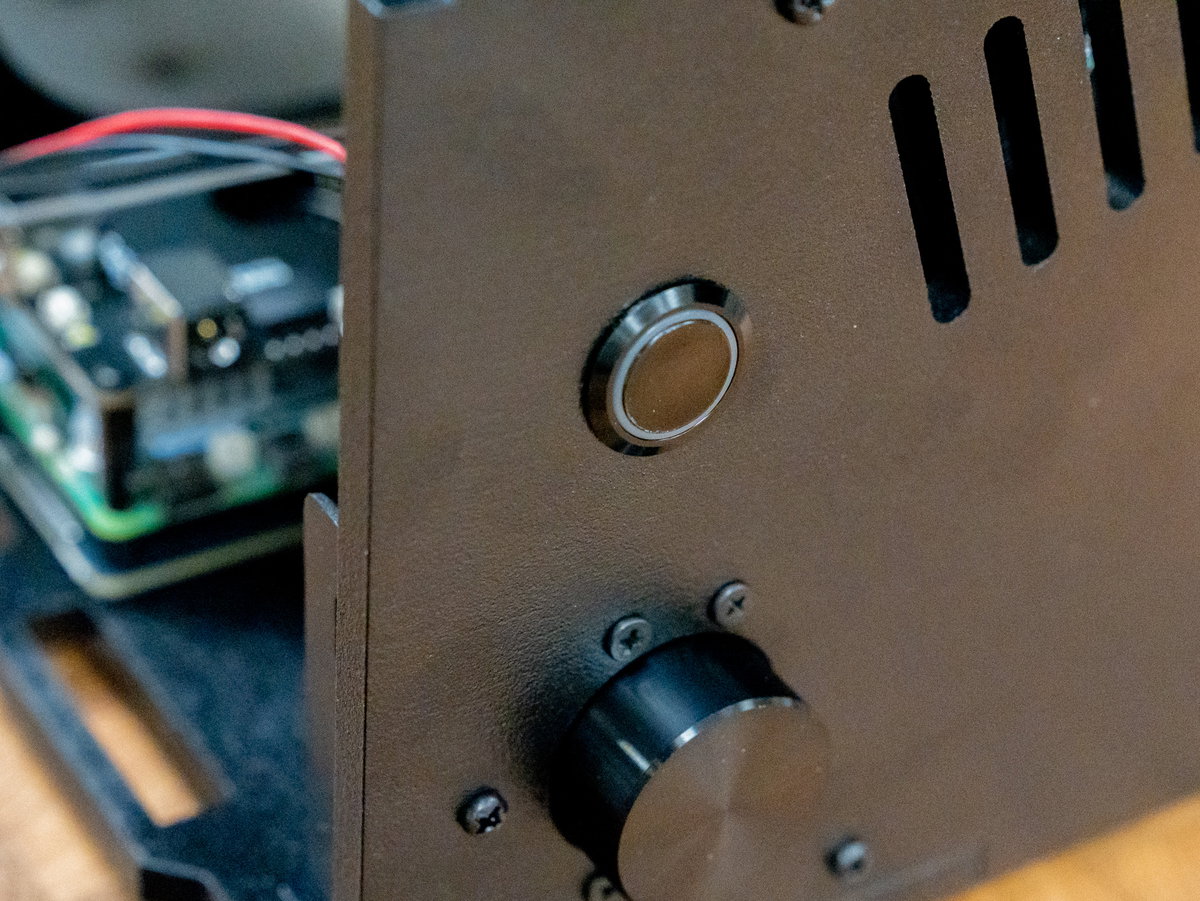 Illuminated power button and wires inserted through panel E