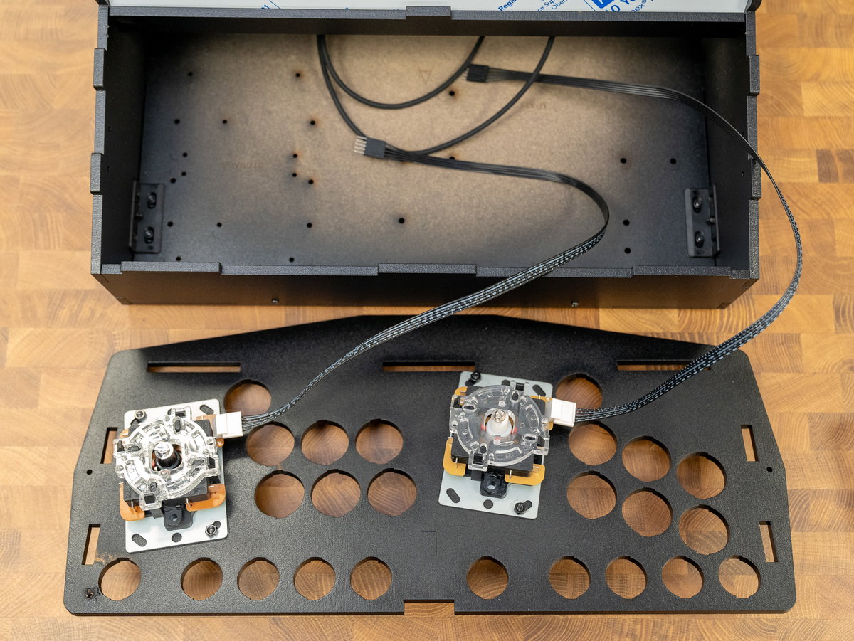 Two-player console panel positioned in front of the cabinet with joystick cables routed inside