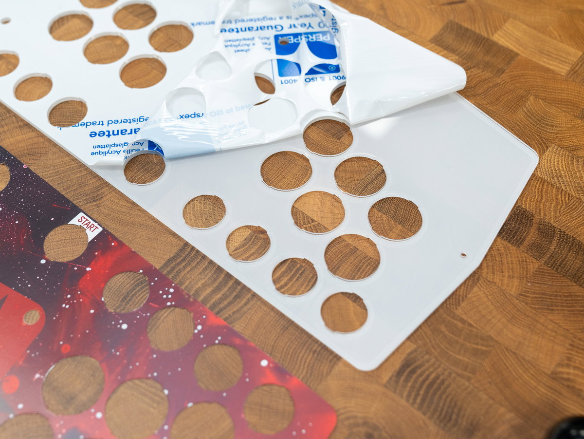 Protective coating being removed from the two-player acrylic panel