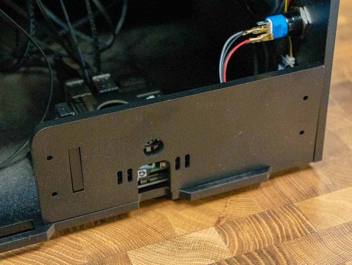 Backplate J tab inserted into the slot on panel B