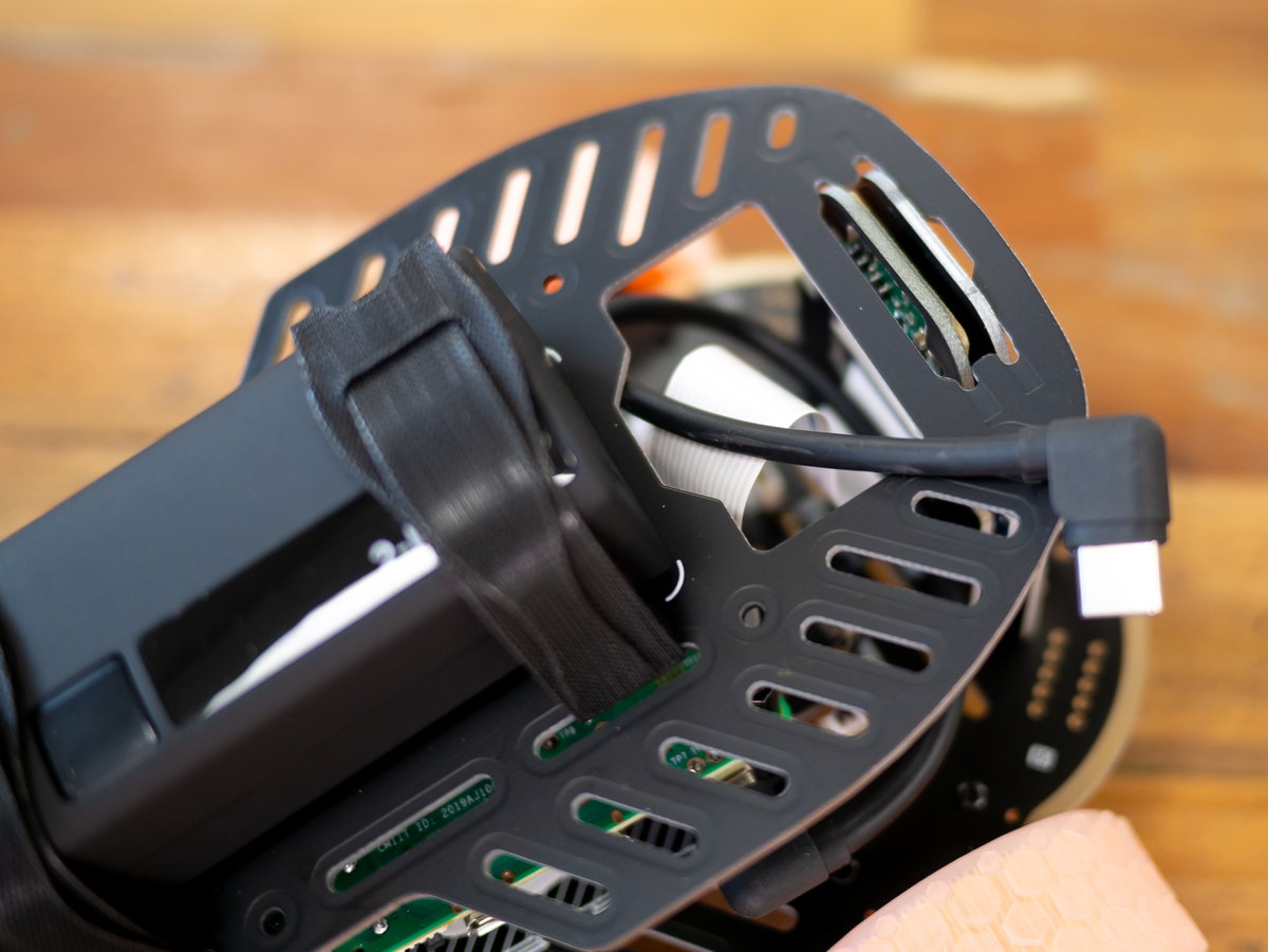 Poking the USB-C cable and front/camera boards through the holes in the top