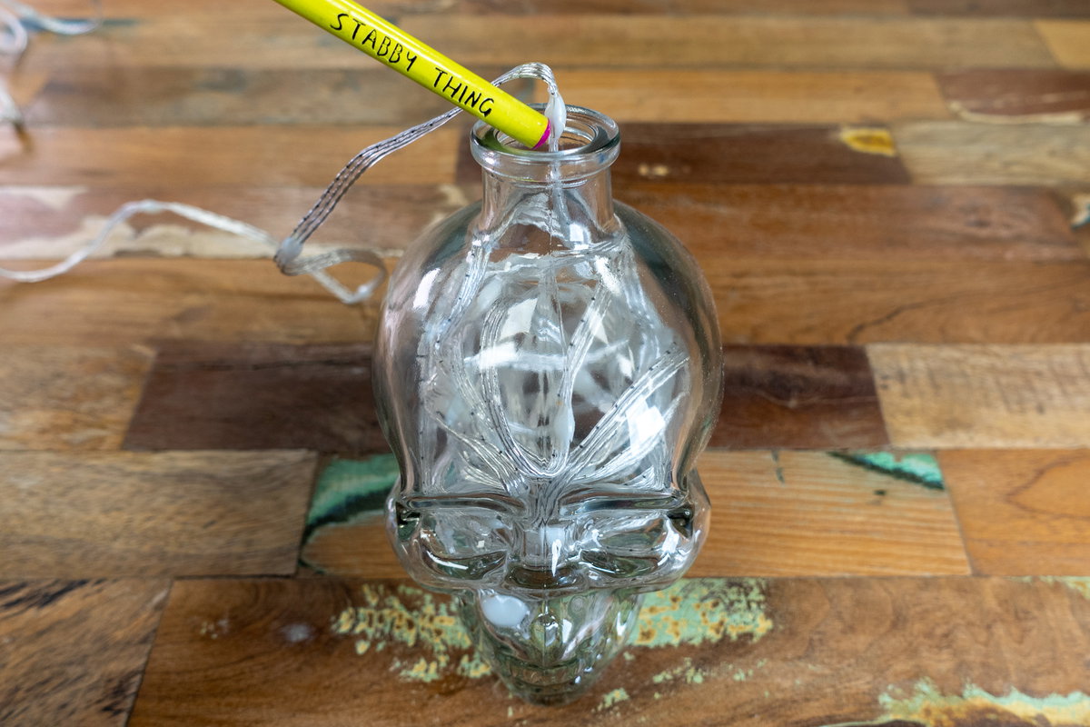 Poking the LED wire into the bottle