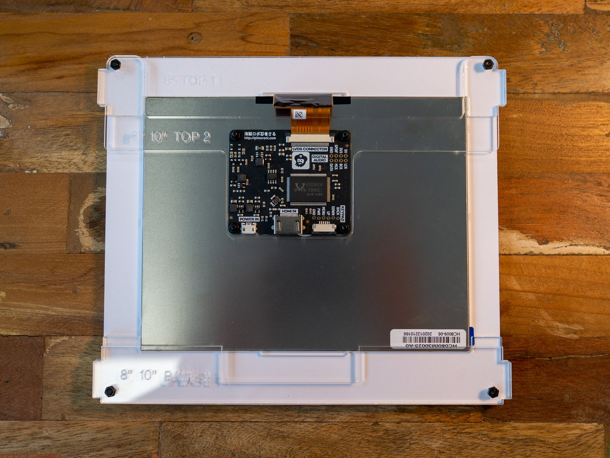 Acrylic piece marked 8 10 BASE 2 fitted to the screen assembly