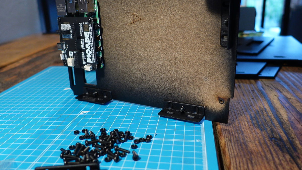 Five plastic corner brackets fitted to Picade panel A