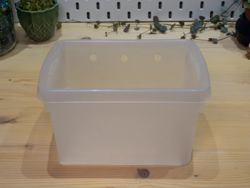 Plastic box with holes drilled for tubes