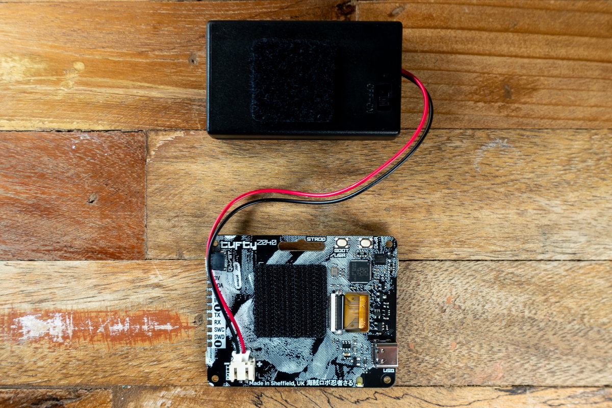 Tufty and battery pack with Velcro squares stuck on