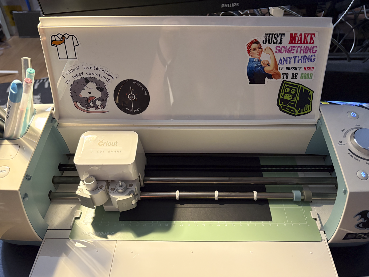 Cricut cutting machine cutting a bezel from black card