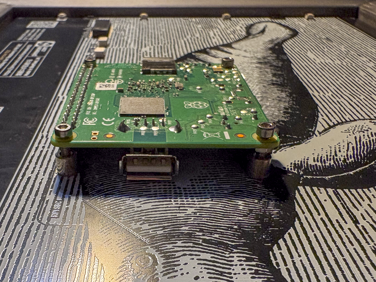 Pi plugged into Inky Impression and secured with hex screws, from the side