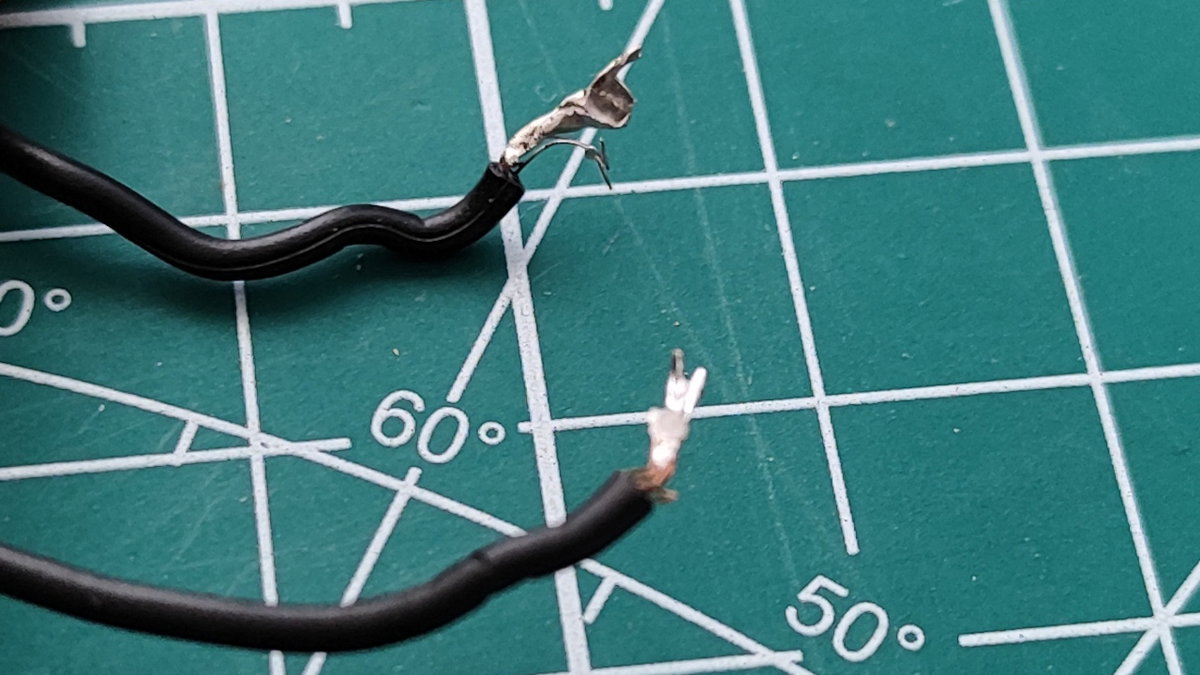 Image of badly soldered wires pulled from the battery case